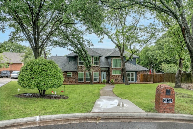 view of front of house with roof with shingles and brick siding