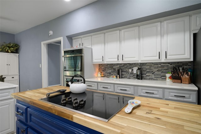 kitchen with butcher block counters, white cabinets, decorative backsplash, and black electric cooktop