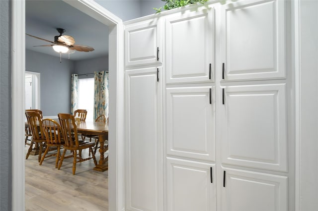 dining space with ceiling fan and light wood finished floors