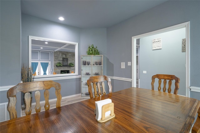 dining area featuring a fireplace, recessed lighting, and baseboards