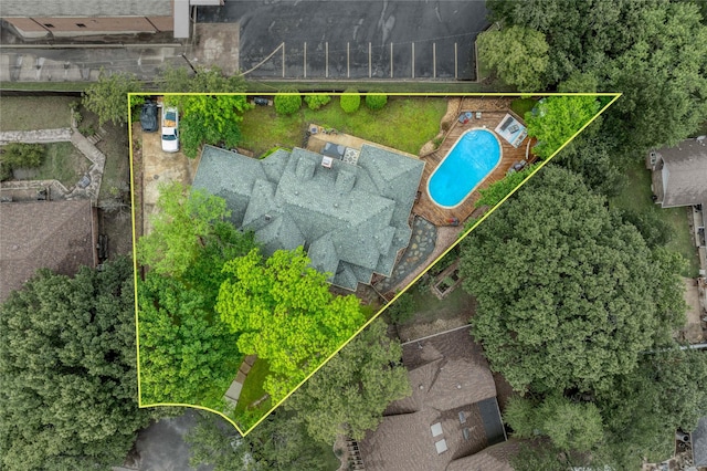 aerial view of property and surrounding area featuring property boundaries highlighted and a pool area