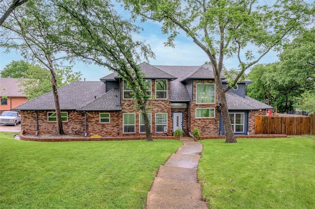 tudor house with a shingled roof and brick siding