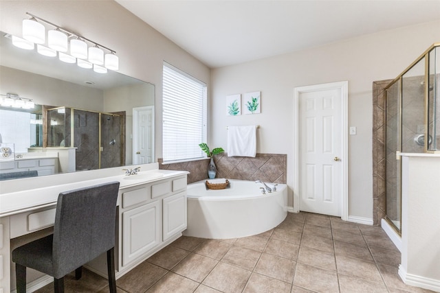 full bath featuring a stall shower, tile patterned flooring, vanity, and a bath