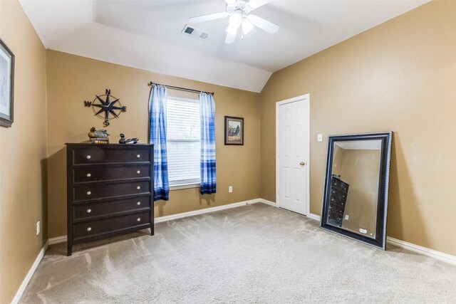 carpeted bedroom featuring lofted ceiling, baseboards, and a ceiling fan