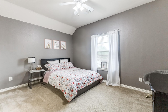 carpeted bedroom featuring lofted ceiling, baseboards, and a ceiling fan