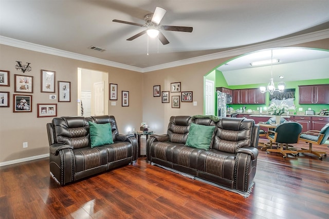 111 Evening Star Cir, Red Oak, TX 75154 - living room featuring ceiling fan, arched walkways, a chandelier, dark wood-style flooring, and crown molding