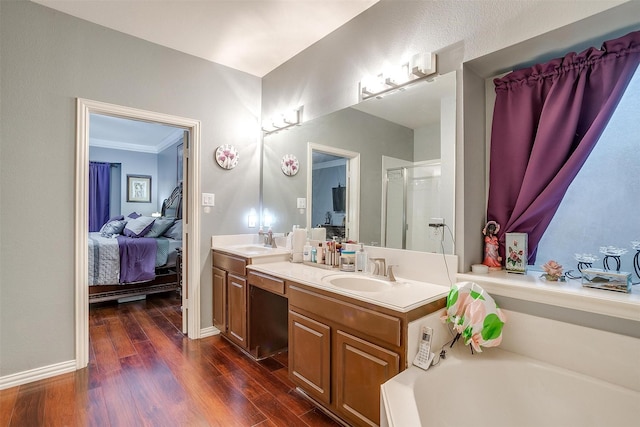 111 Evening Star Cir, Red Oak, TX 75154 - ensuite bathroom with double vanity, a shower stall, wood finished floors, a garden tub, and baseboards