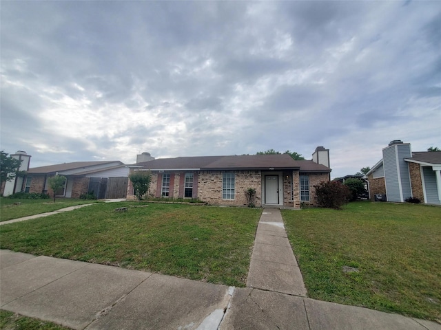 1425 Brazos Dr, Mesquite, TX 75150 - ranch-style house with brick siding, a front yard, and a chimney