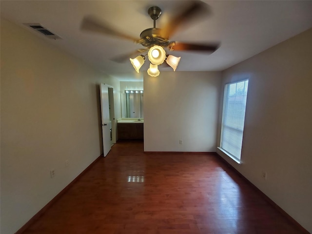 1425 Brazos Dr, Mesquite, TX 75150 - empty room featuring a ceiling fan, wood finished floors, and baseboards
