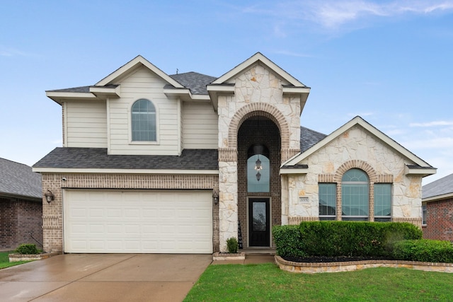 2015 Diamondback, Forney, TX 75126 - view of front facade with stone siding, an attached garage, concrete driveway, and brick siding
