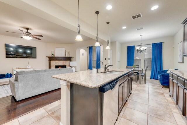 2015 Diamondback, Forney, TX 75126 - kitchen featuring dishwasher, a sink, a ceiling fan, light stone counters, and arched walkways