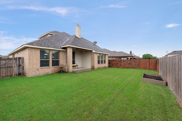 2015 Diamondback, Forney, TX 75126 - back of property with brick siding, roof with shingles, a patio area, and a chimney