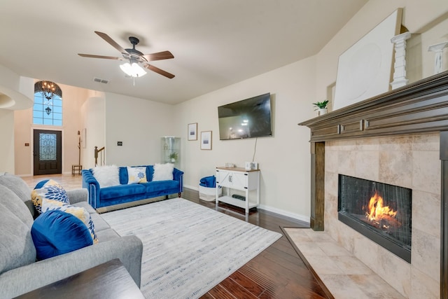 2015 Diamondback, Forney, TX 75126 - living room with a fireplace, light wood-type flooring, baseboards, a ceiling fan, and arched walkways