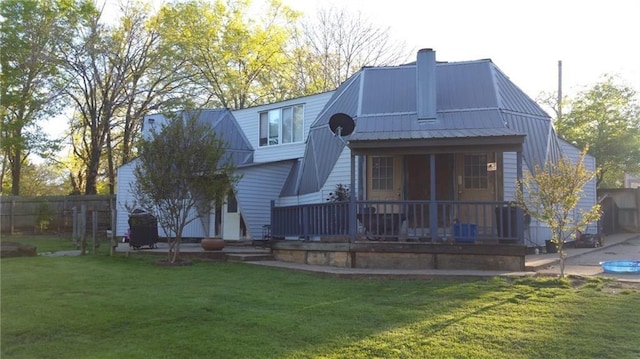 135 Whitaker Cir, Gordonville, TX 76245 - back of property featuring a chimney, metal roof, and a porch