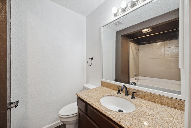 2634 Pinta Cir, Grand Prairie, TX 75052 - bathroom with toilet, vanity, a textured wall, washtub / shower combination, and baseboards