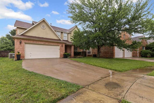 traditional home with driveway, stucco siding, and brick siding