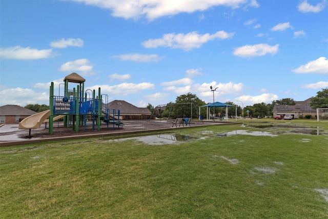 community jungle gym featuring a lawn