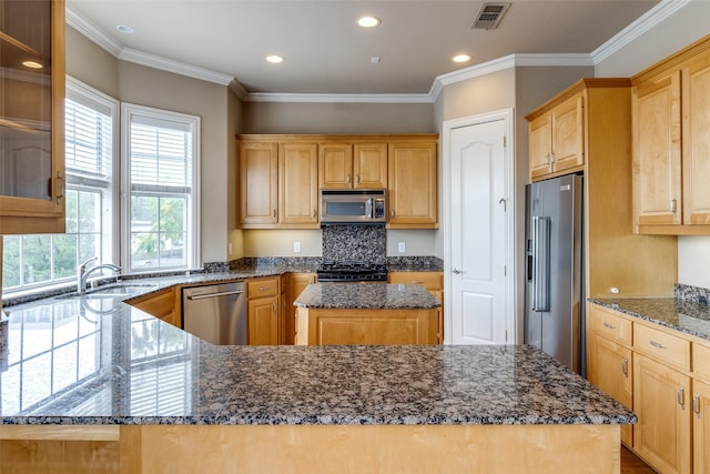2813 Welborn St, Dallas, TX 75219 - kitchen with appliances with stainless steel finishes, dark stone countertops, a sink, a center island, and recessed lighting