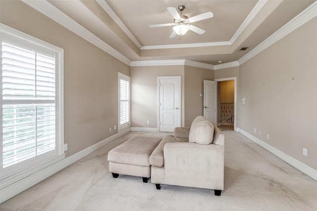 2813 Welborn St, Dallas, TX 75219 - living area featuring a raised ceiling, light colored carpet, ceiling fan, crown molding, and baseboards