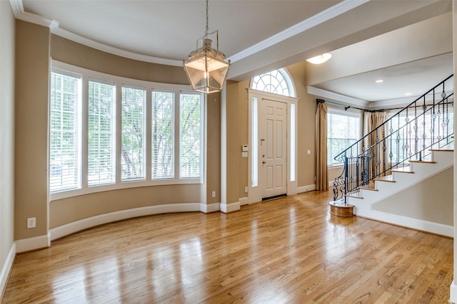 2813 Welborn St, Dallas, TX 75219 - foyer with wood finished floors, ornamental molding, baseboards, and stairway