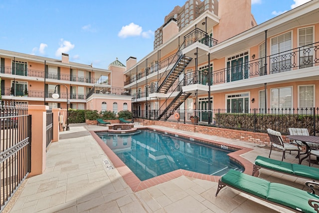 3208 Cole Ave Unit 2304, Dallas, TX 75204 - community pool featuring an in-ground hot tub and a patio