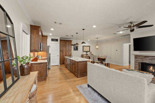 3208 Cole Ave Unit 2304, Dallas, TX 75204 - living area featuring ornamental molding, recessed lighting, light wood finished floors, a fireplace, and a ceiling fan