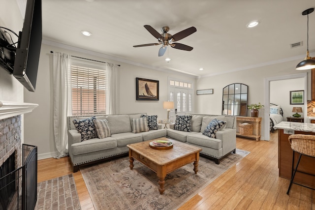 3208 Cole Ave Unit 2304, Dallas, TX 75204 - living room with a ceiling fan, crown molding, a fireplace, light wood-type flooring, and recessed lighting