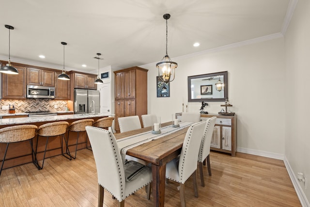3208 Cole Ave Unit 2304, Dallas, TX 75204 - dining area featuring light wood-type flooring, baseboards, recessed lighting, and crown molding