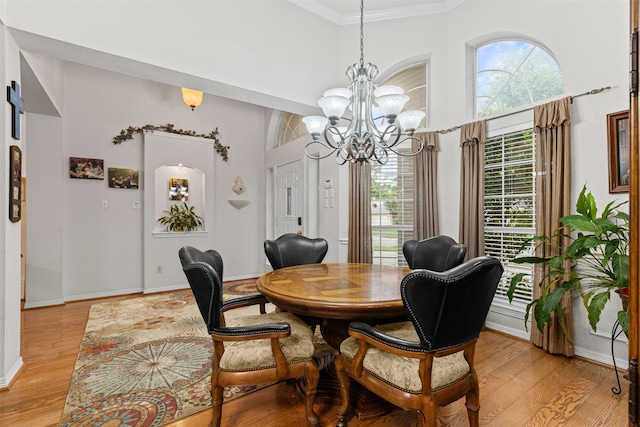 4119 Timbersedge Trl, Arlington, TX 76015 - dining area with a chandelier, light wood-type flooring, baseboards, crown molding, and a towering ceiling