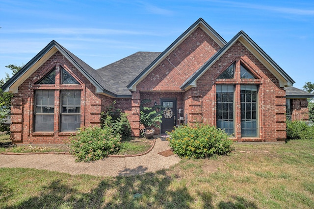 7508 Lake Highlands Dr, Fort Worth, TX 76179 - traditional-style house with brick siding, a front lawn, and a shingled roof