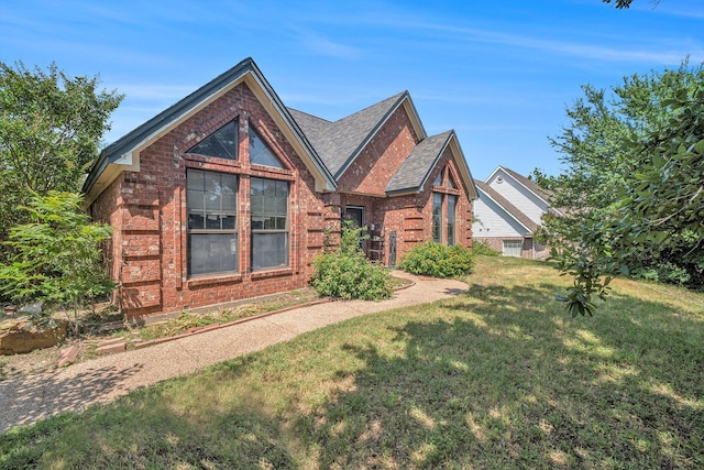 7508 Lake Highlands Dr, Fort Worth, TX 76179 - view of front of property featuring brick siding, a front yard, and roof with shingles