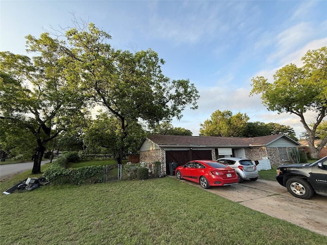 view of front of home featuring a front yard, concrete driveway, and an attached garage