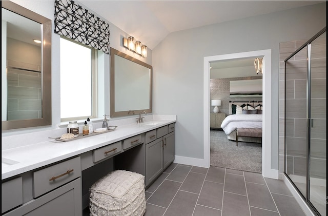 full bath featuring plenty of natural light, vaulted ceiling, double vanity, tile patterned floors, and a shower stall