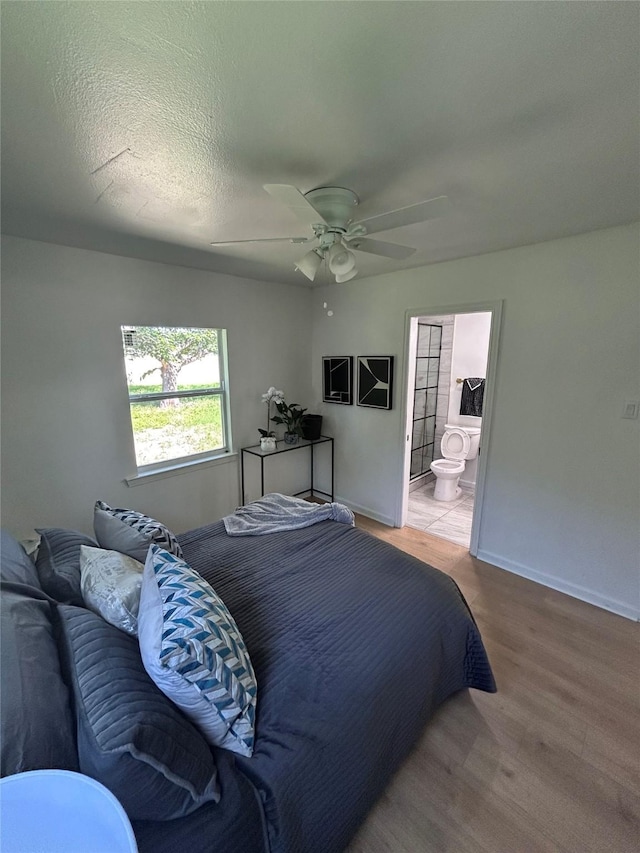 1034 Shawnee Trce, Grand Prairie, TX 75051 - bedroom with wood finished floors, connected bathroom, and a ceiling fan
