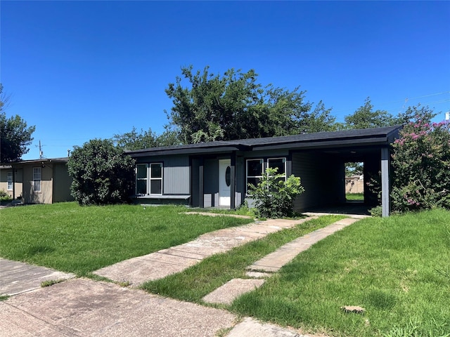1034 Shawnee Trce, Grand Prairie, TX 75051 - view of front of house featuring a front lawn and a carport