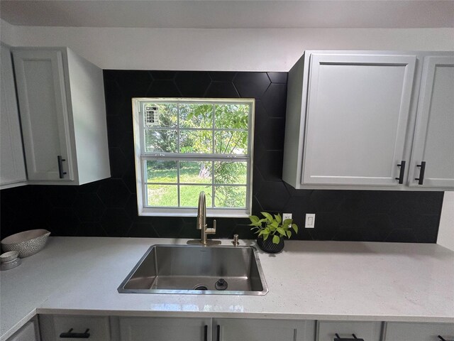 1034 Shawnee Trce, Grand Prairie, TX 75051 - kitchen with light countertops, backsplash, and white cabinetry