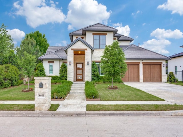 view of front of home with driveway, a garage, stucco siding, stone siding, and a tiled roof