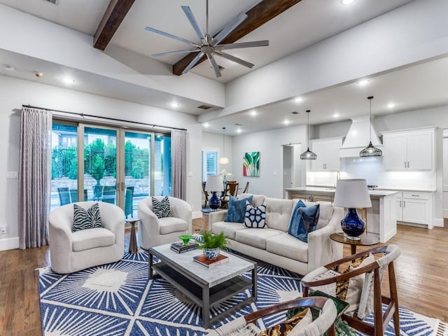 living room featuring a ceiling fan, beamed ceiling, light wood finished floors, recessed lighting, and baseboards