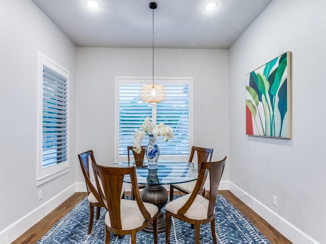 dining space featuring wood finished floors, a chandelier, baseboards, and recessed lighting