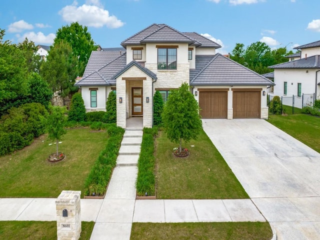 view of front of home featuring stone siding, a garage, stucco siding, concrete driveway, and a tiled roof