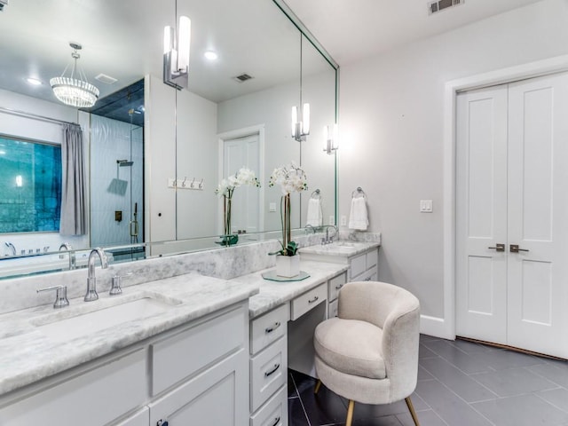 full bathroom with a shower stall, double vanity, tile patterned floors, and baseboards