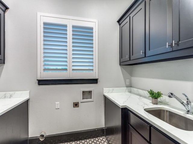 washroom featuring cabinet space, hookup for a washing machine, electric dryer hookup, and baseboards