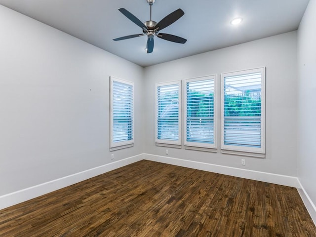 unfurnished room featuring baseboards, healthy amount of natural light, dark wood-style flooring, and recessed lighting