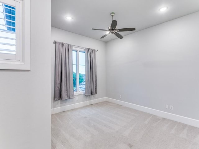 carpeted spare room featuring baseboards, ceiling fan, and recessed lighting