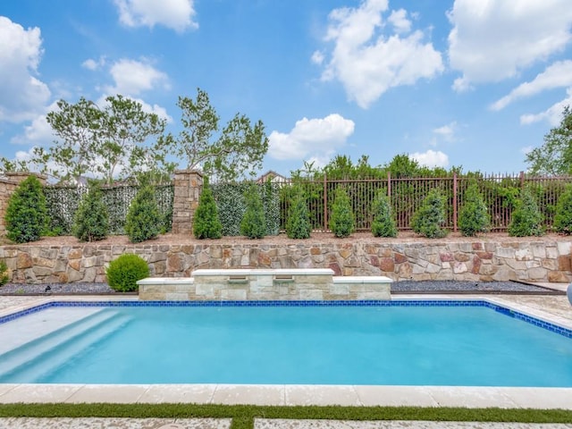 view of swimming pool with a fenced backyard