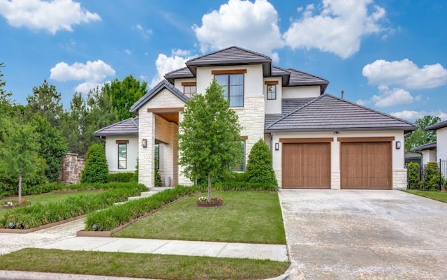 view of front facade with stone siding, an attached garage, stucco siding, concrete driveway, and a front lawn