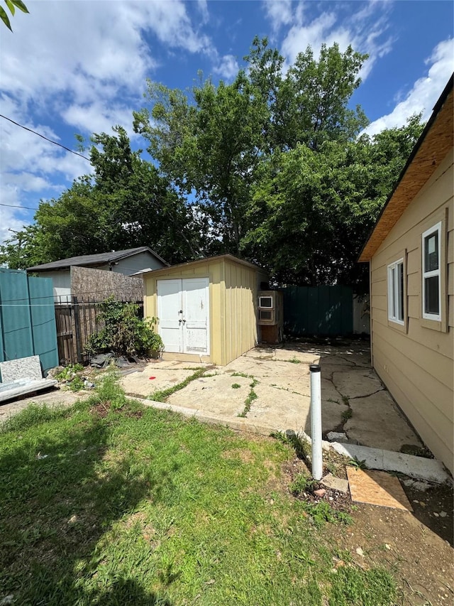 view of yard with a storage unit, an outdoor structure, and a patio