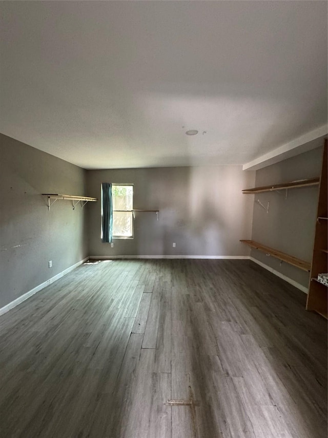 spare room with wood finished floors and baseboards