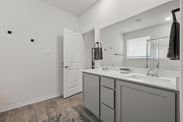 3409 Brady Starr Dr, Aubrey, TX 76227 - bathroom with a shower stall, wood finished floors, double vanity, and baseboards