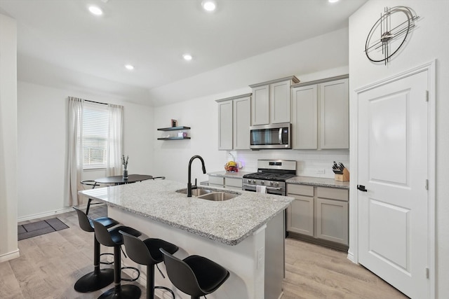3409 Brady Starr Dr, Aubrey, TX 76227 - kitchen with appliances with stainless steel finishes, a sink, gray cabinetry, a center island with sink, and recessed lighting